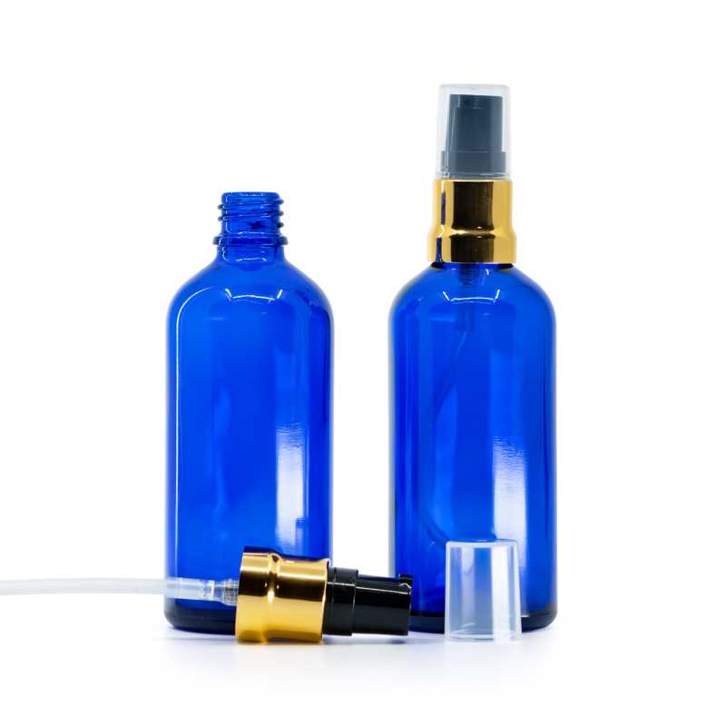 Skleněná láhev, modrá, černo-zlatý dávkovač, průhledný vrch, 100 ml